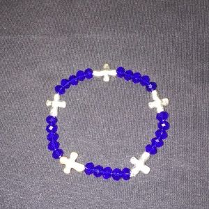 Bracelet with royal blue beads and silver crosses.